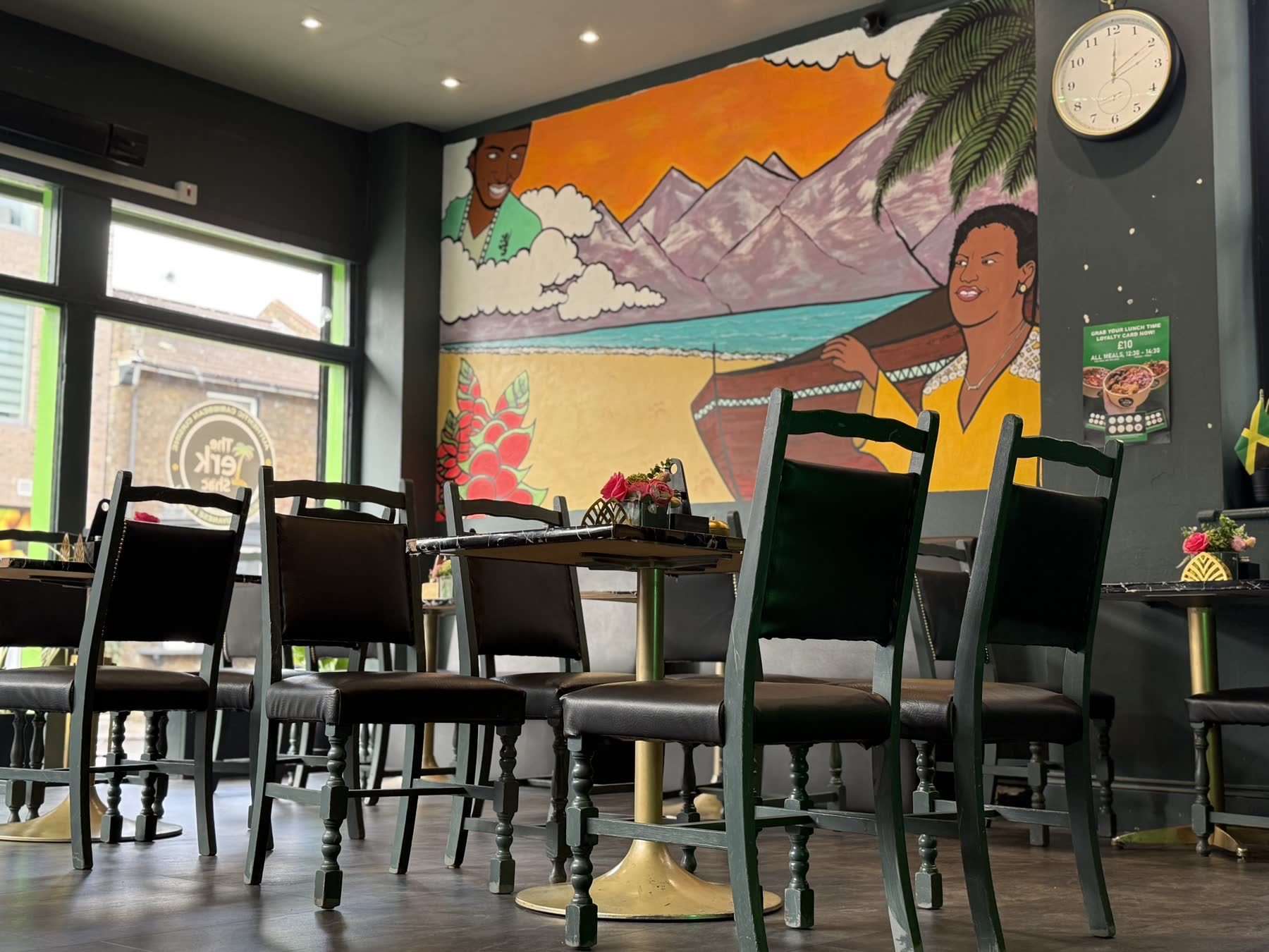 Interior mural and seating at The Jerk Shac